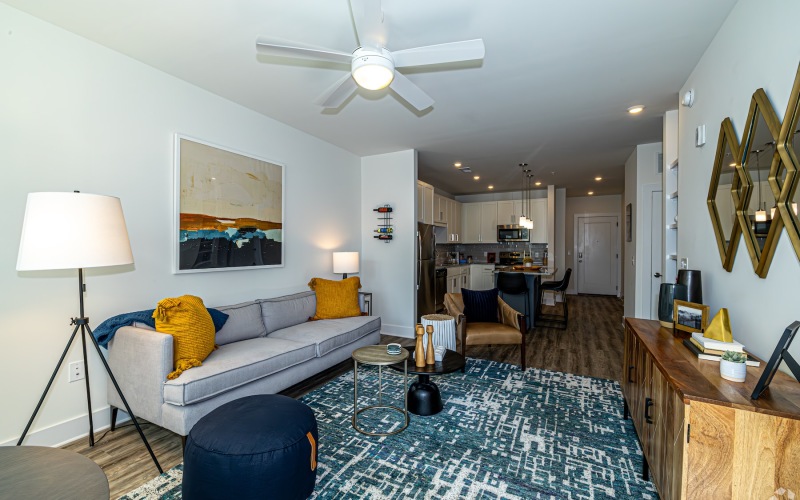 a living room with a couch and a fan