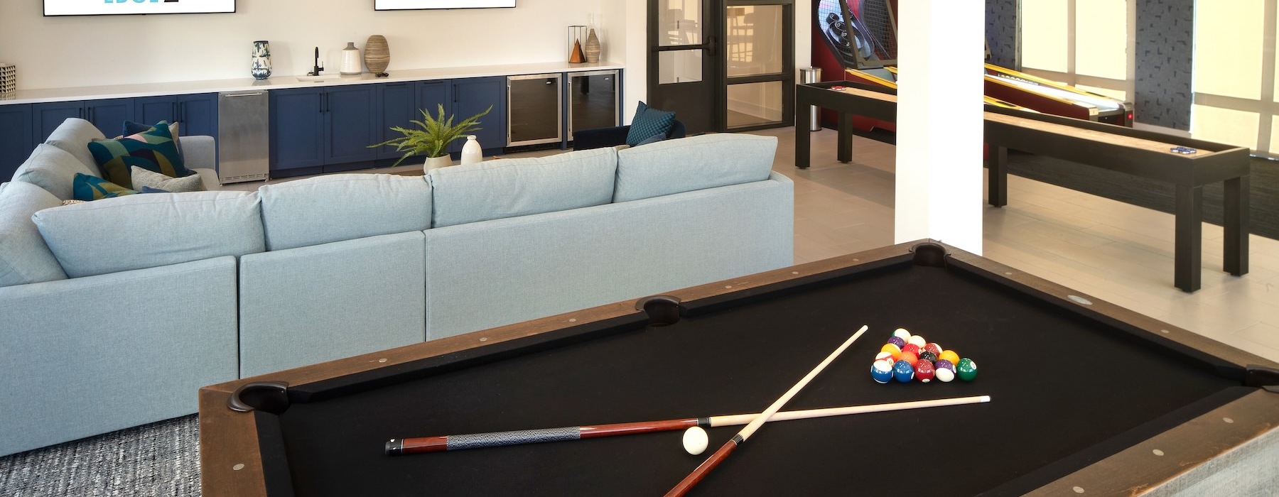 a clubroom with a pool table and a couch