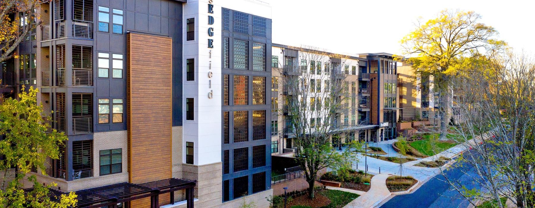 a building with trees and a walkway
